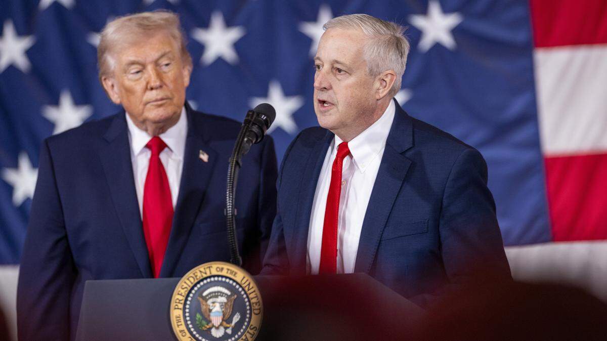 Republican U.S. Senate primary candidate Michael Whatley, right, who is endorsed by President Donald Trump, speaks alongside the president to soldiers from the XVIII Airborne Corps at Fort Bragg in Fayetteville Friday, Feb. 13, 2026.