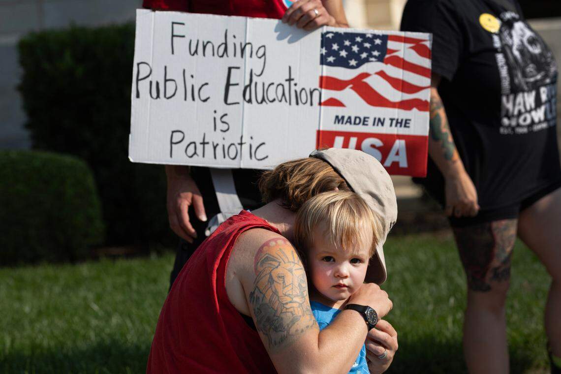 People gather outside the Alamance County Courthouse to protest budget cuts to the library system and its social services in Graham, N.C. on June 2, 2025.