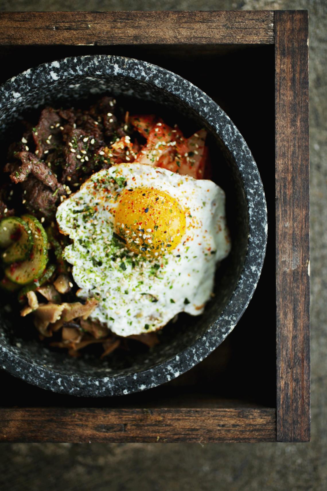 Seoul 116’s true-to-form rendition of bibimbap, presented in a stone bowl, is a culinary kaleidoscope of soy-marinated rib-eye, kimchi, shiitakes, scallions, bean sprouts and a fried egg.
