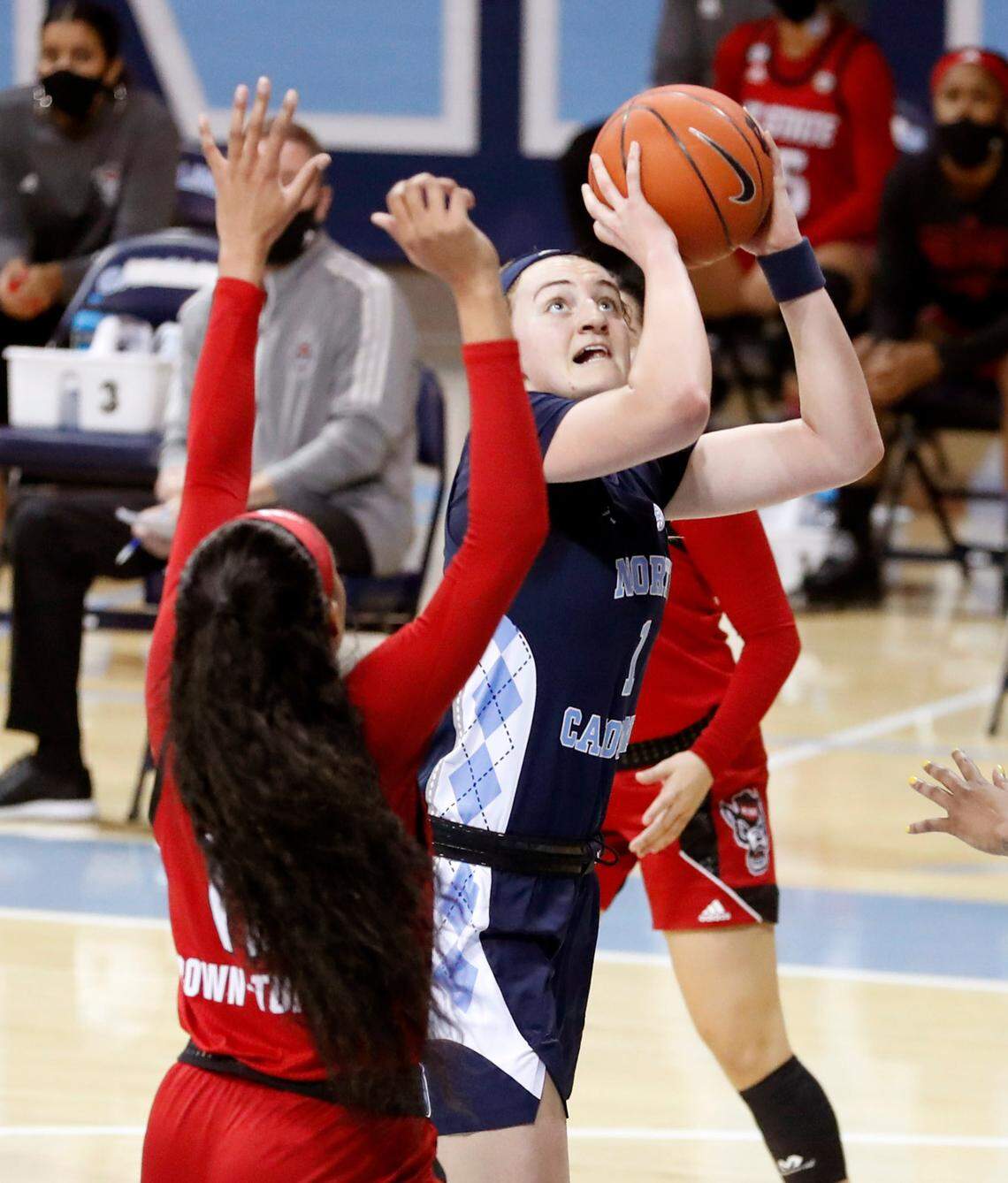 North Carolina’s Alyssa Ustby (1) shoots as N.C. State’s Jakia Brown-Turner (11) defends during the first half of N.C. State’s game against UNC at Carmichael Arena in Chapel Hill, N.C., Sunday, February 7, 2021.