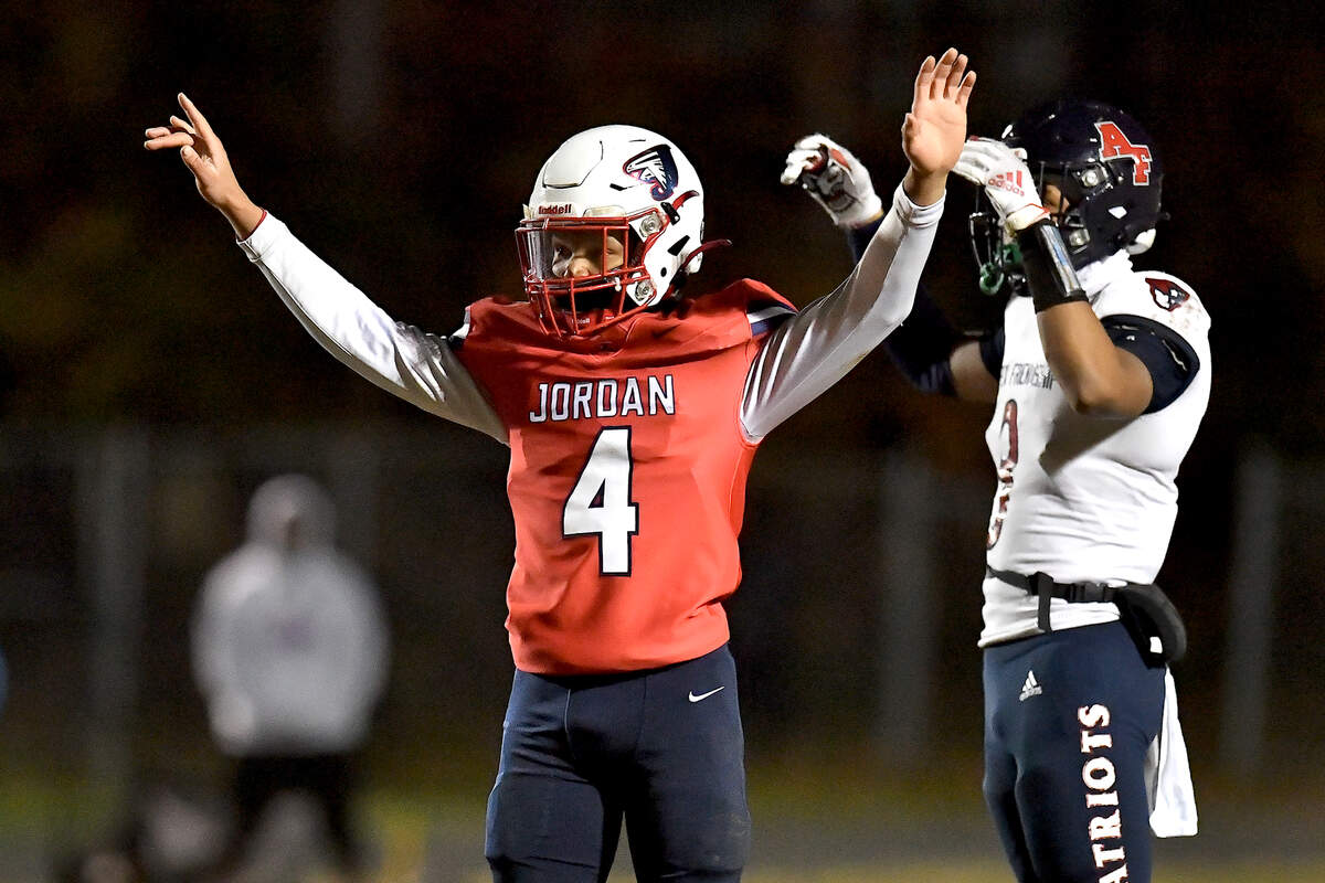 Jordan’s Ezekiel Stokes (4) reacts after interrupting the pass to Apex Friendship’s Braden Bloom (8) during the first half. The Apex Friendship Patriots and the Durham Jordan Falcons met in the second round of the NCHSAA 4A playoffs in Durham, N.C. on November 22, 2024.