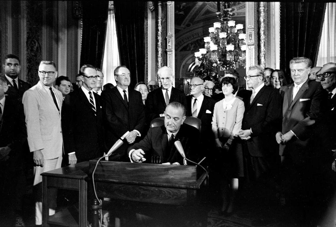 In this Aug. 6, 1965, photo, President Lyndon Baines Johnson signs the Voting Rights Act of 1965 in a ceremony in the President’s Room near the Senate Chambers on Capitol Hill in Washington. Surrounding the president from left directly above his right hand, Vice President Hubert Humphrey; House Speaker John McCormack; Rep. Emanuel Celler, D-N.Y.; first daughter Luci Johnson; and Sen. Everett Dirksen, R-Ill. Behind Humphrey is House Majority Leader Carl Albert of Oklahoma; and behind Celler is Sen. Carl Hayden, D-Ariz.