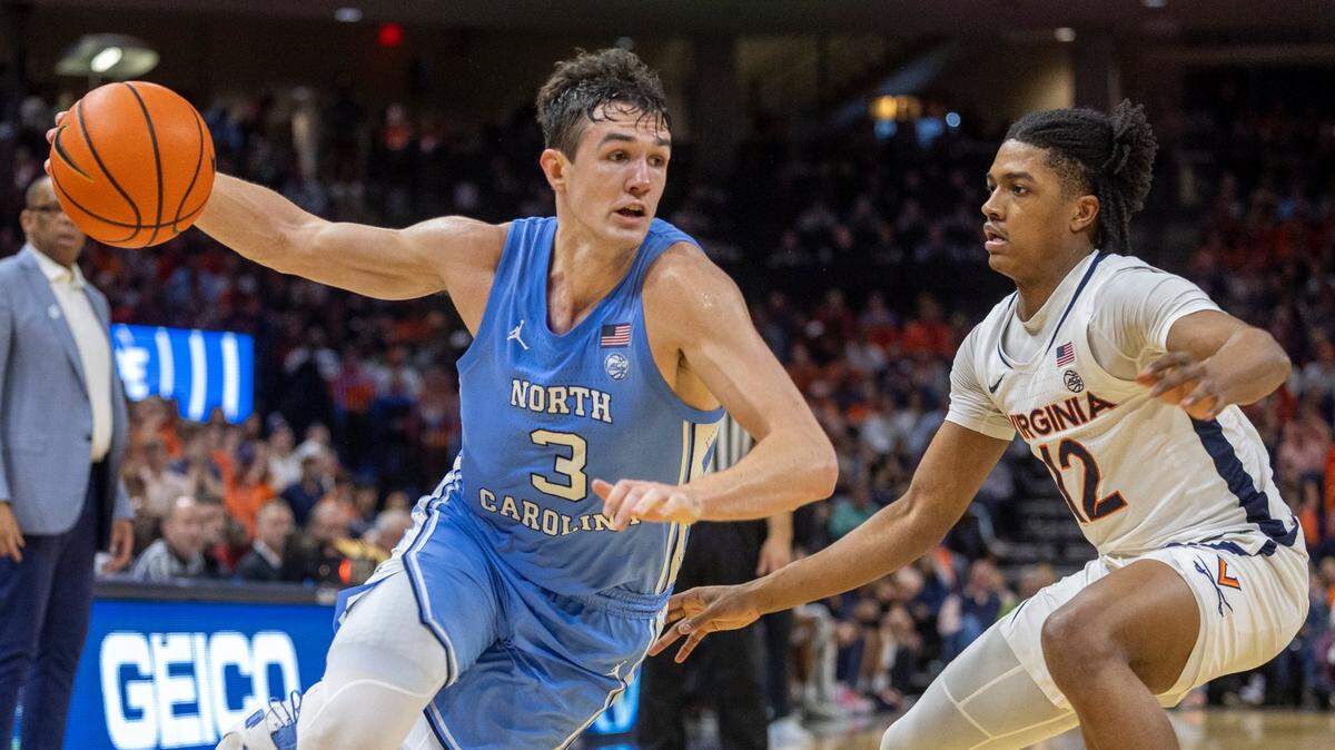 North Carolina’s Cormac Ryan (3) drives to the basket against Virginia’s Elijah Gertrude (12) in the second half on Saturday, February 24, 2024 at John Paul Jones Arena in Charlottesville, Va.