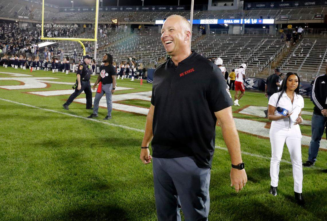 N.C. State head coach Dave Doeren laughs with his players as they head off the field after N.C. State’s 24-14 victory over UConn at Rentschler Field in East Hartford, Conn. Thursday, August 31, 2023.