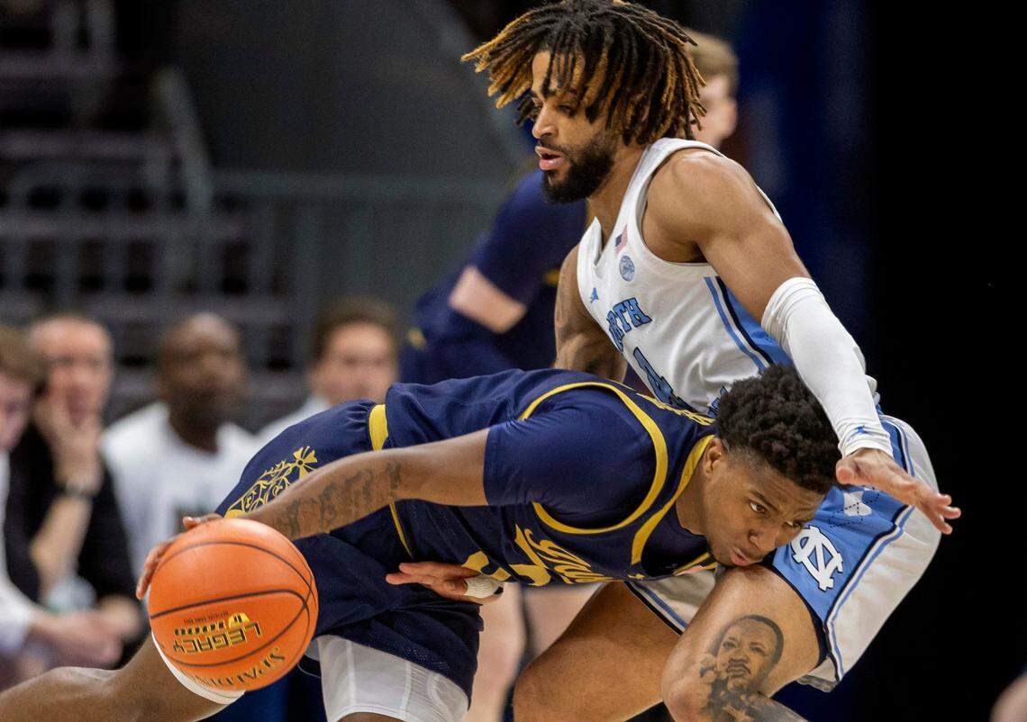 North Carolina guard R.J. Davis (4) defends Notre Dame’s Marcus Burton (3) in the second half on Wednesday, March 12, 2025 during the second round of the ACC Tournament at Spectrum Center in Charlotte, N.C.