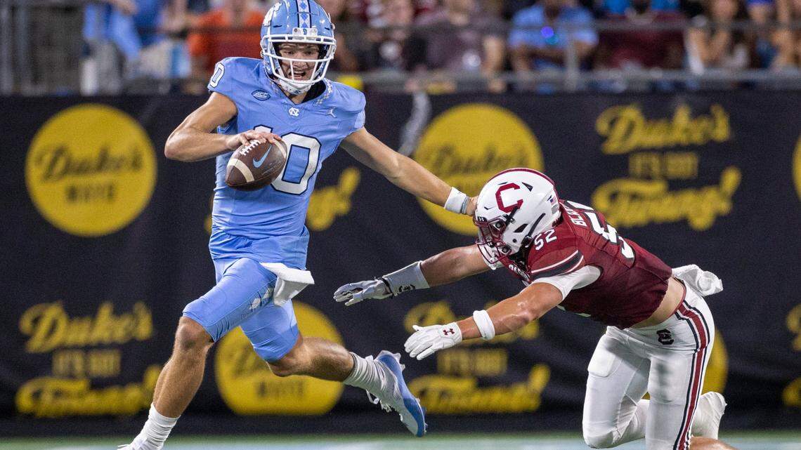 North Carolina quarterback Drake Maye (10) breaks away from South Carolina’s Stone Blanton (52) in the second quarter on Saturday September 2, 2023 at Bank of America Stadium in Charlotte, N.C.