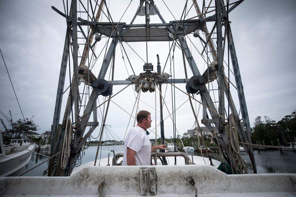 David Wheatly does a final rope check after he and his crew took down and tied up the nets of his shrimping boat, the Addie Gage, before heading home to prepare for Hurricane Dorian on Wednesday, Sept. 4, 2019.