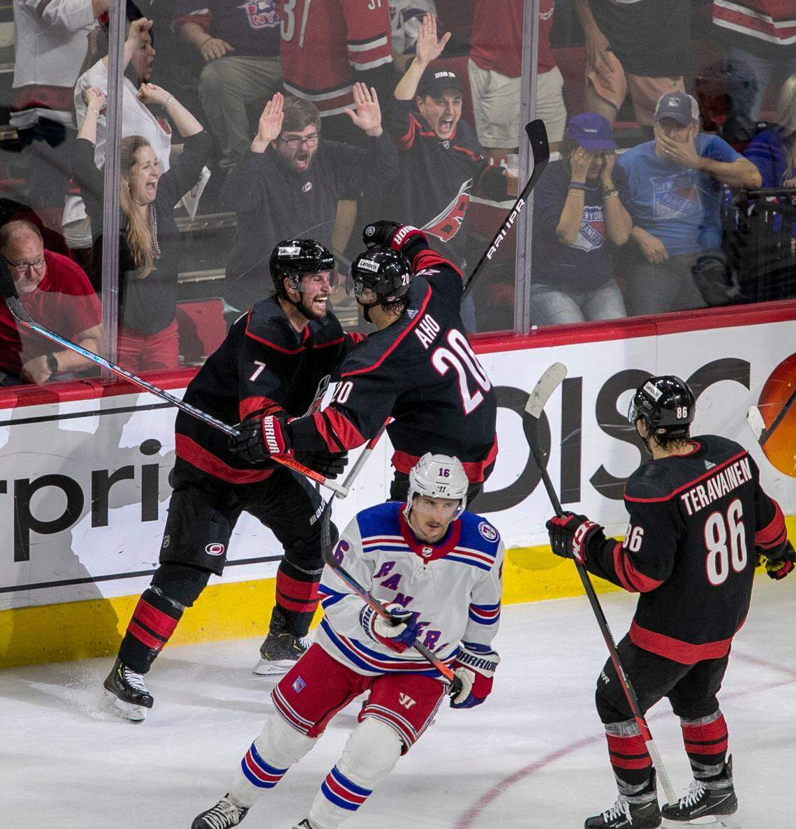 Carolina Hurricanes Brendan Smith (7) and Sebastian Aho (20) react after Smiths goal on New York Rangers goalie Igor Shesterkin (31) to give the Hurricanes a 1-0 lead in the second period on Friday, May 20, 2022 during game two of the Stanley Cup second round at PNC Arena in Raleigh, N.C.