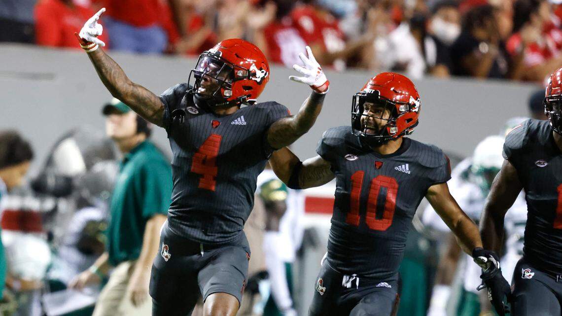 N.C. State’s Cyrus Fagan (4) and Tanner Ingle (10) celebrate an interception by Fagan during the second half of N.C. State’s 45-0 victory over USF at Carter-Finley Stadium in Raleigh, N.C., Thursday, Sept. 2, 2021.