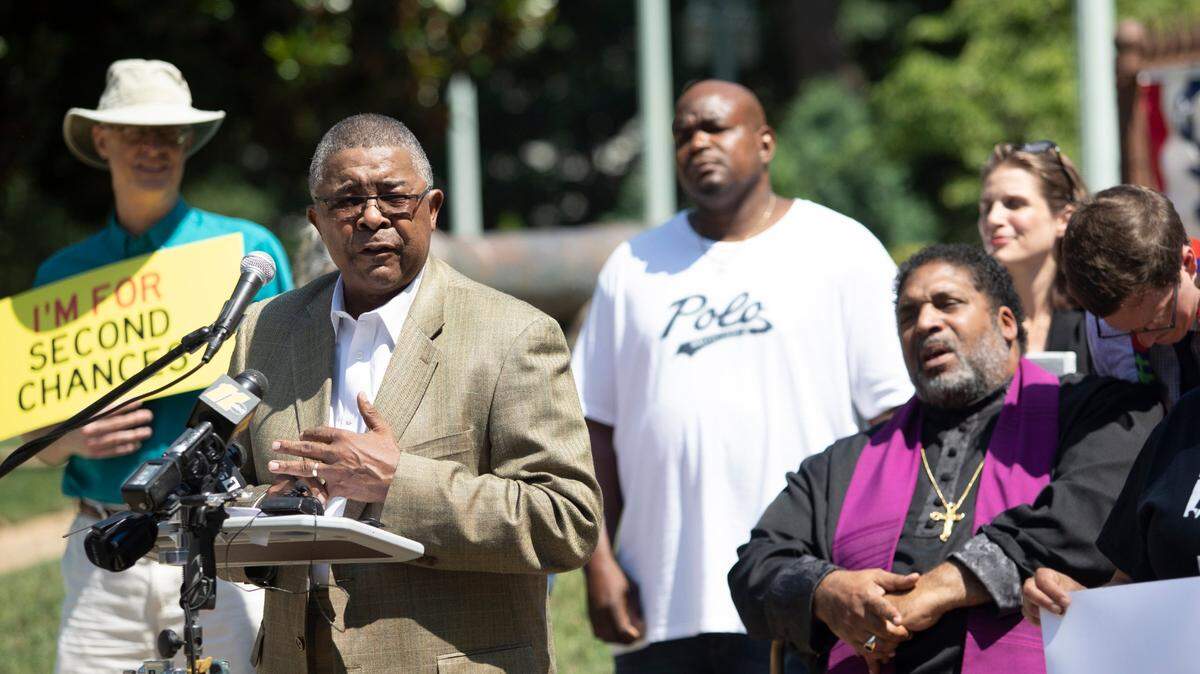 Dennis Gaddy, pictured here at a rally calling for a pardon for a wrongfully convicted man, is also behind the lawsuit seeking to give tens of thousands of felons back their voting rights after they leave prison.
