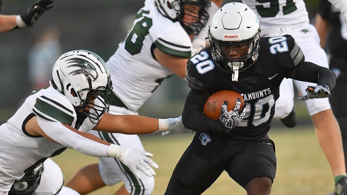 Panther Creek’s Kalen Luten (20) runs for yardage against Green Hope’s Jack Falter (9) during the first half. The Green Hope Falcons and the Panther Creek Catamounts met in a football game in Raleigh, N.C. on September 23, 2022.