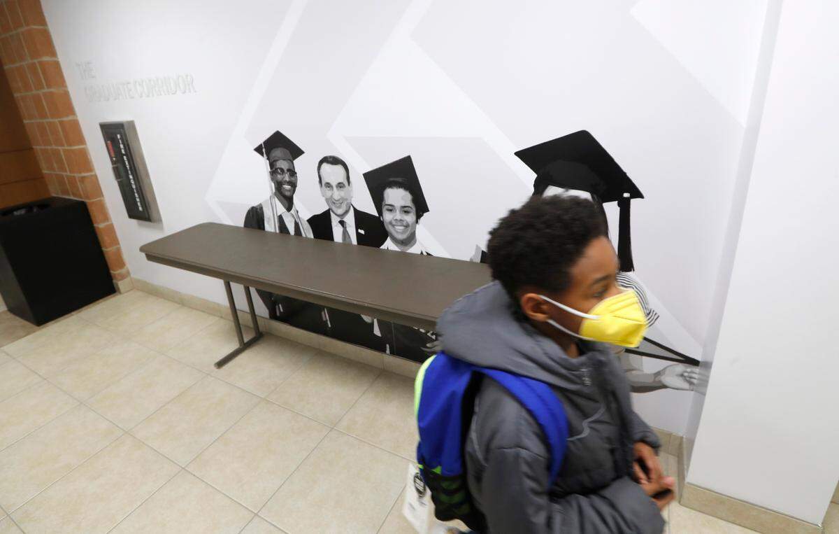 Second-grader Tre’Sean Lawrence walks down the halls at the Emily K Center in Durham, N.C., Thursday, Feb. 24, 2022.
