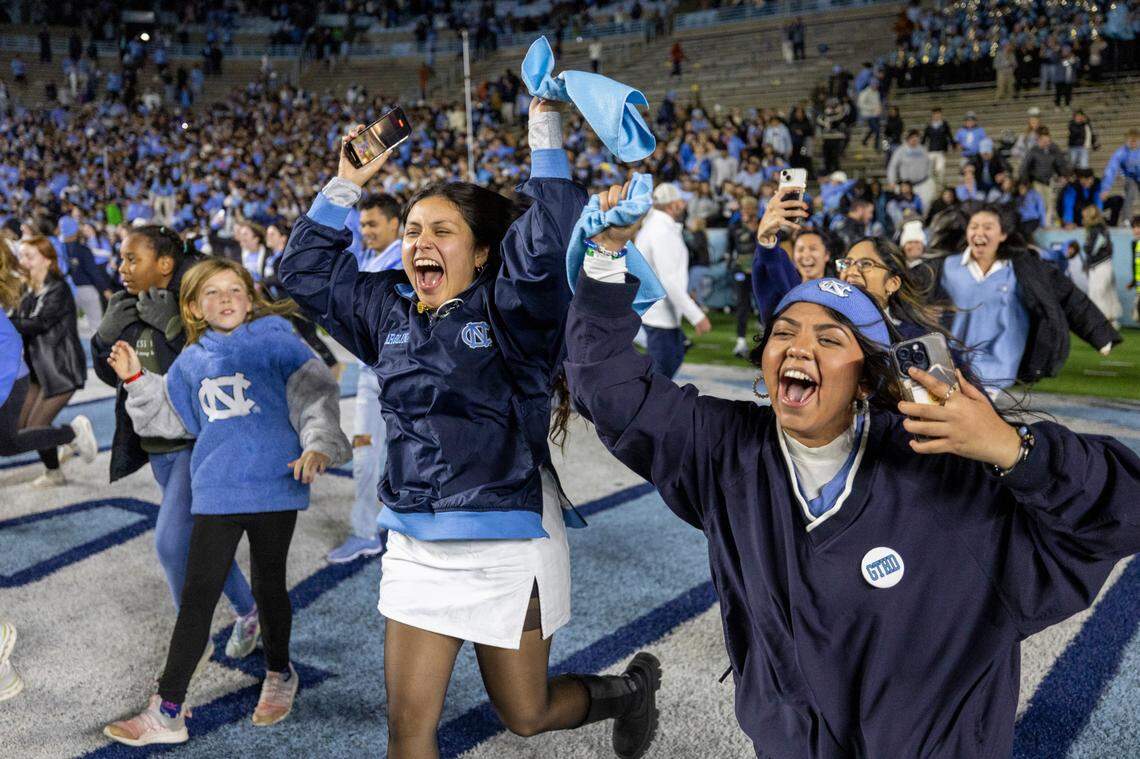 North Carolina fans storm the field following their 47-45 double overtime victory against Duke on Saturday, Nov. 11, 2023 at Kenan Stadium in Chapel Hill, N.C.