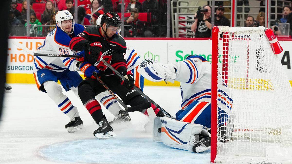 Carolina Hurricanes center Jesperi Kotkaniemi (82) takes the puck to the net against Edmonton Oilers defenseman John Klingberg (36) and goaltender Calvin Pickard (30) during the first period at Lenovo Center.