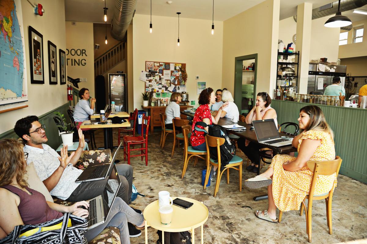 East Durham Bake Shop has a friendly neighborhood feel with a long communal table, floral couch and a reading nook.