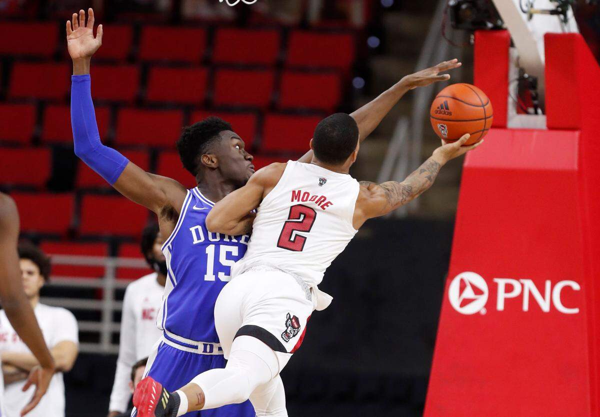 Duke’s Mark Williams (15) blocks the shot by N.C. State’s Shakeel Moore (2) during the second half of Duke’s 69-53 victory over N.C. State at PNC Arena in Raleigh, N.C., Saturday, February 13, 2021.