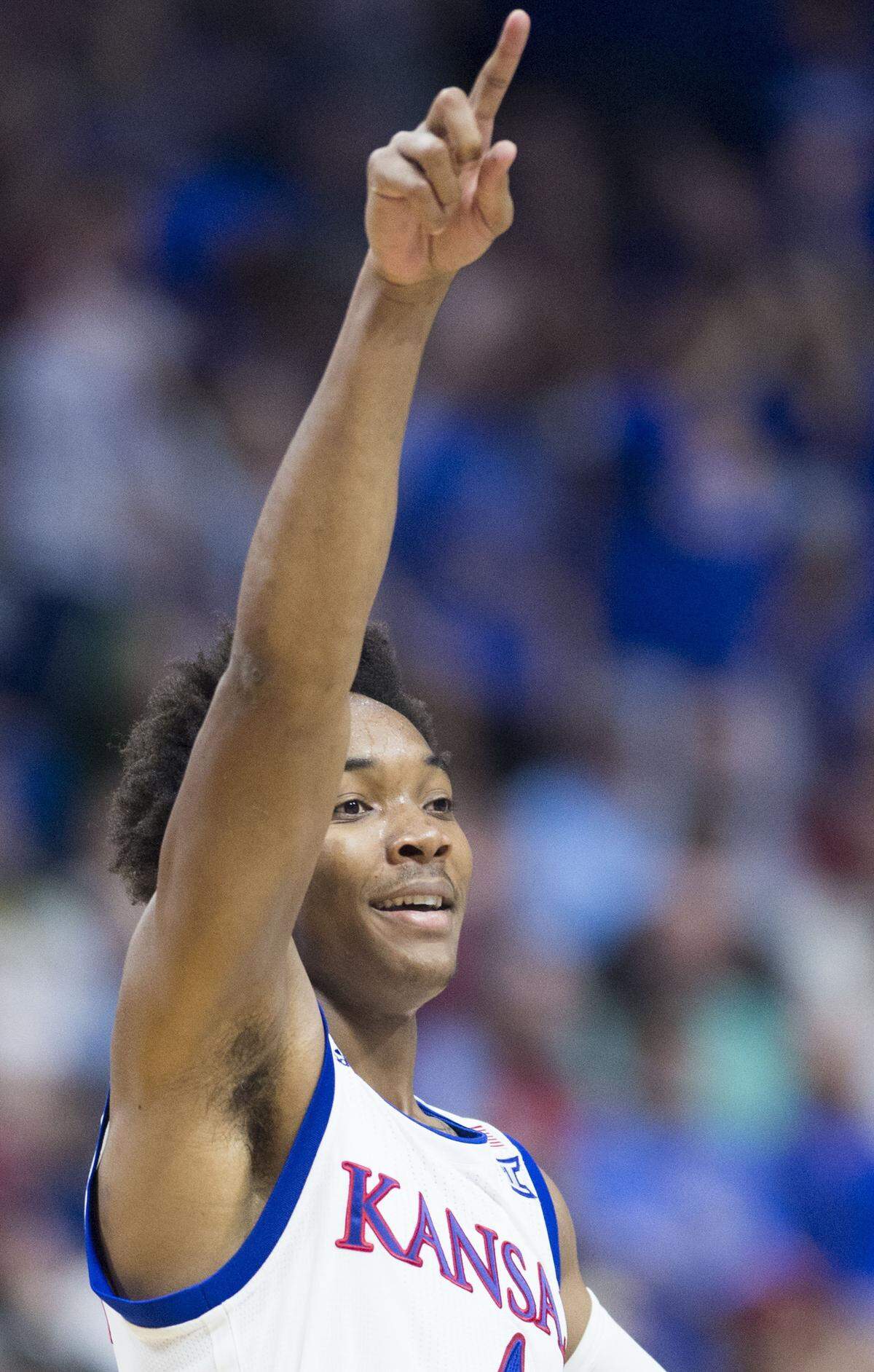 Kansas Jayhawks guard Devonte' Graham (4) celebrates after making a three-pointer in the second half during the University of Kansas and Michigan State University second round NCAA Tournament basketball game at the BOK Center on Sunday, March 19, 2017, in Tulsa, Oklahoma. The Jayhawks beat Michigan State 90-70.