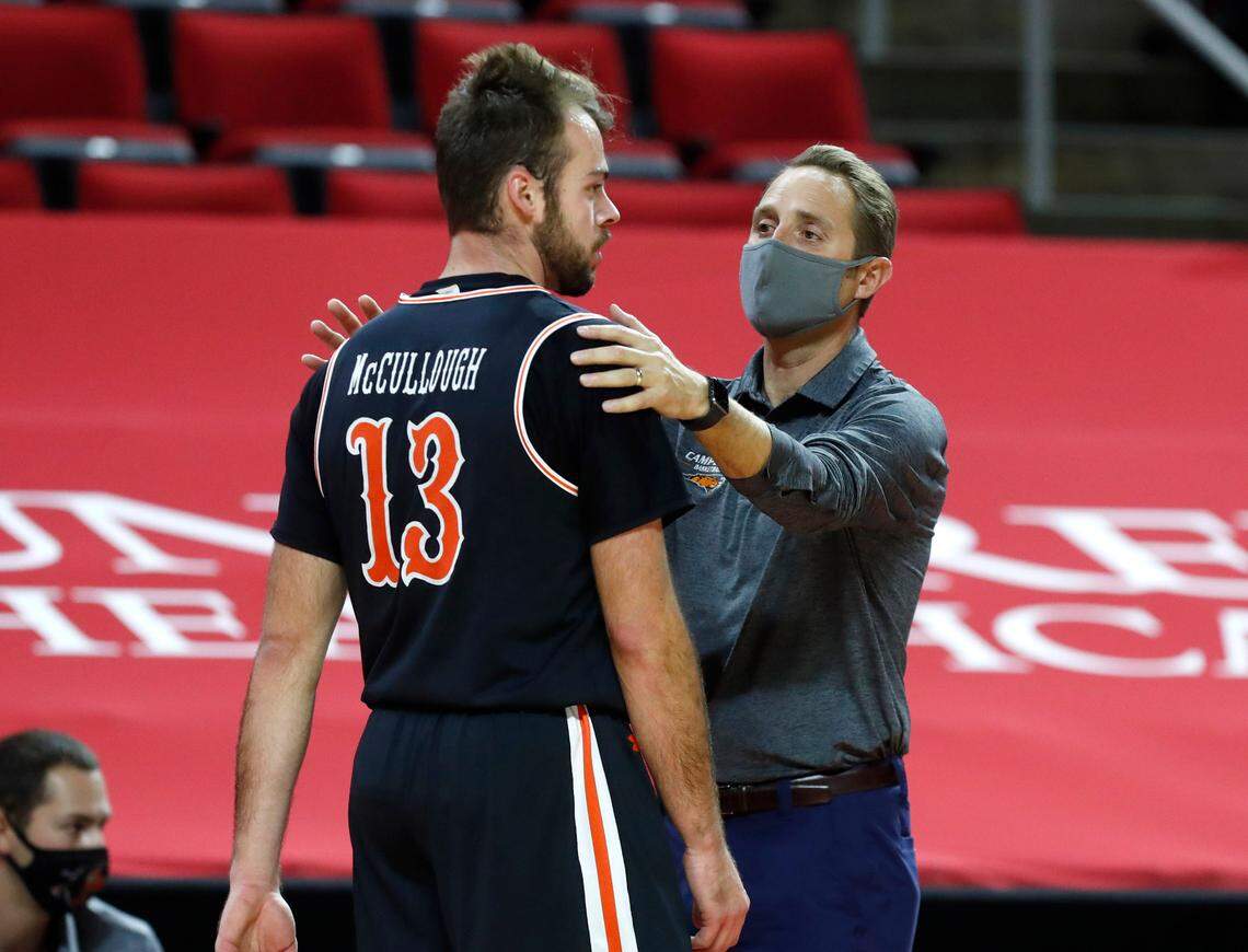 Campbell’s head coach Kevin McGeehan talks with Austin McCullough (13) during the first half of N.C. State’s game against Campbell at PNC Arena in Raleigh, N.C., Saturday, Dec. 19, 2020.