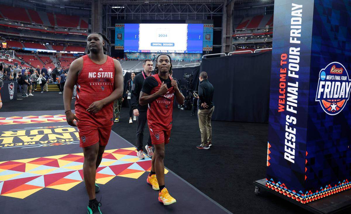 N.C. State’s DJ Burns Jr. and DJ Horne walk off the arena floor area after the Wolfpack’s practice at State Farm Stadium in Glendale, Ariz., Friday, April 5, 2024. The Wolfpack will face Purdue in the NCAA Tournament national semifinals Saturday.