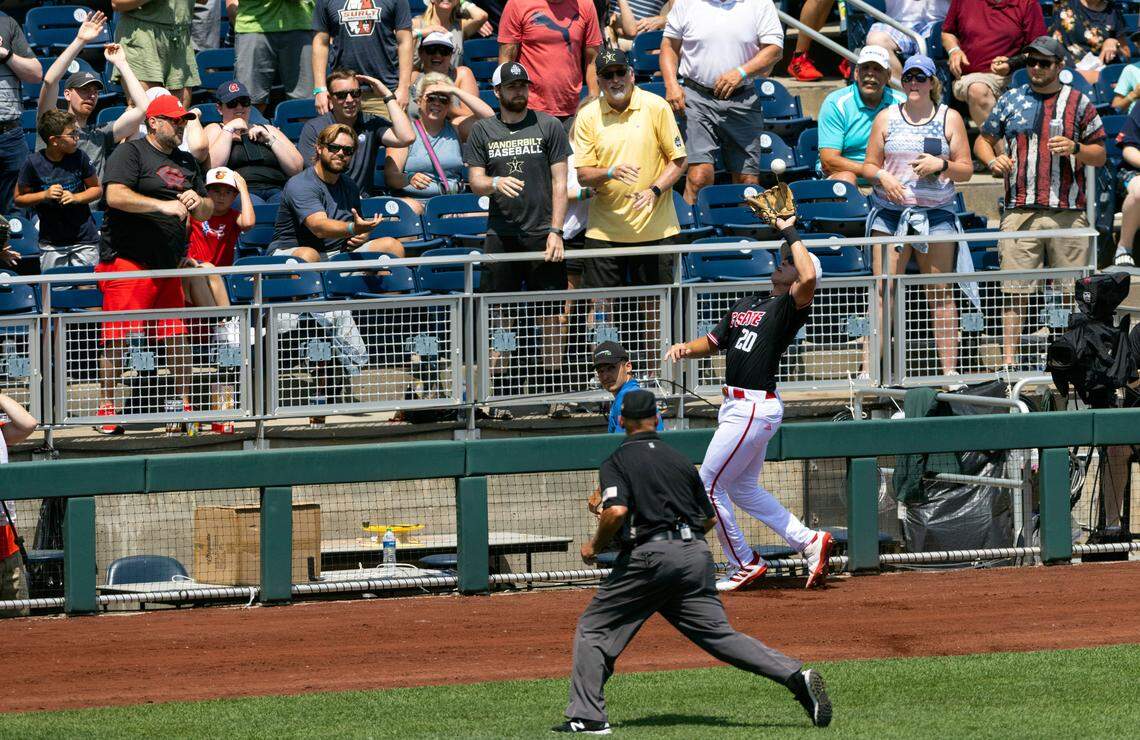 North Carolina State’s DeAngelo Giles (20) catches a foul ball hit by Vanderbilt’s Enrique Bradfield Jr. in the third inning of a baseball game in the College World Series, Friday, June 25, 2021, at TD Ameritrade Park in Omaha.