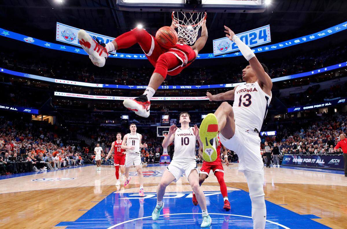 N.C. State’s Casey Morsell (14) slams in two as Virginia’s Ryan Dunn (13) defends during N.C. State’s 72-65 overtime victory over Virginia in the semifinals of the 2024 ACC Men’s Basketball Tournament at Capital One Arena in Washington, D.C., Friday, March 15, 2024.