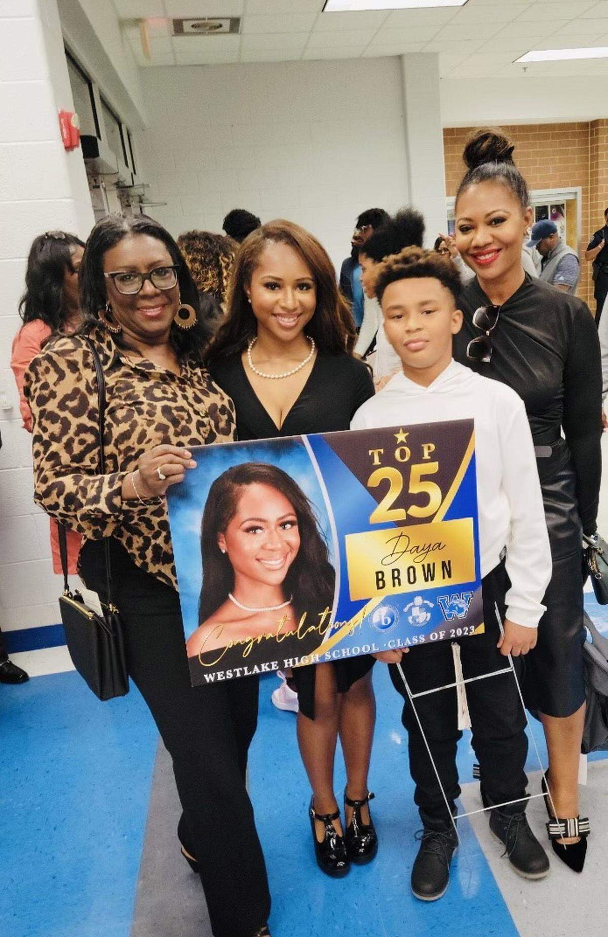 Daya Brown, center, with her grandmother Gertrude Harris, left, her brother Langston Brown and her mother Farrah Brown, at Westlake High School, where she was named one of the school’s top 25 students.