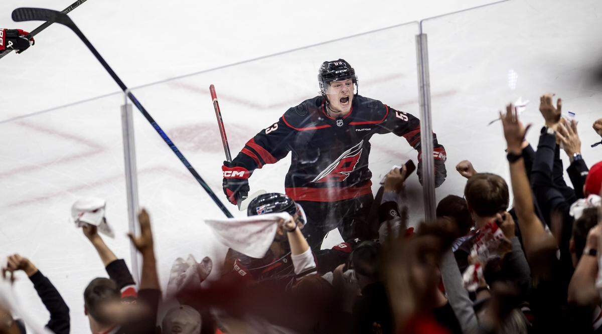 Carolina Hurricanes right wing Jackson Blake (53) celebrates with fans after defeating the Philadelphia Flyers 3-2 in overtime, in Game 2 on Monday, May 4, 2026, during the second round of the Stanley Cup Playoffs at Lenovo Center in Raleigh, N.C.