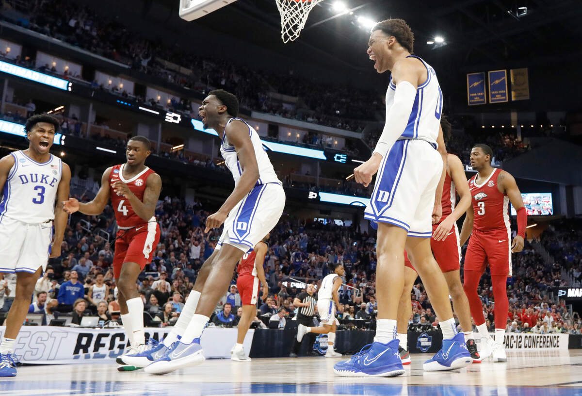 Duke’s Jeremy Roach (3) and Wendell Moore Jr. (0) and Mark Williams (15) react after Williams slammed in two during Duke’s 78-69 victory over Arkansas in the NCAA Tournament West Regional finals at the Chase Center in San Francisco, Calif., Saturday, March 26, 2022.
