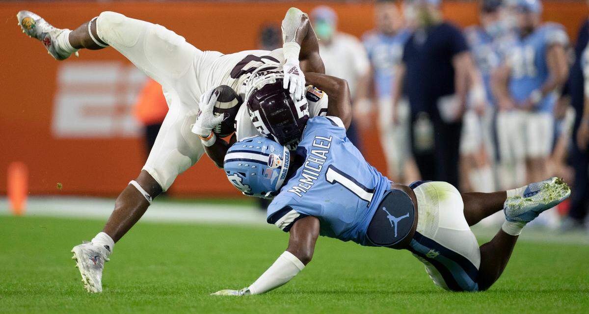 North Carolina’s Kyler McMichael (1) stops Texas A&M’s Ainias Smith (0) after a 14-yard pass completion in the third quarter during the Capital One Orange Bowl on Saturday, January 2, 2021in Miami Gardens, Florida.