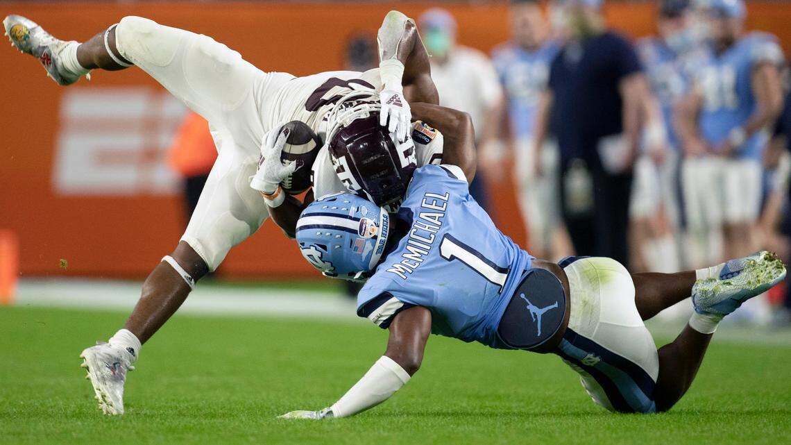 North Carolina’s Kyler McMichael (1) stops Texas A&M’s Ainias Smith (0) after a 14-yard pass completion in the third quarter during the Capital One Orange Bowl on Saturday, January 2, 2021in Miami Gardens, Florida.