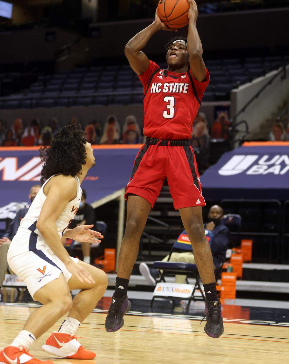 North Carolina State guard Cam Hayes (3) shoots over Virginia guard Kihei Clark (0) during the game Wednesday in Charlottesville, Va. North Carolina State defeated Virginia 68-61.