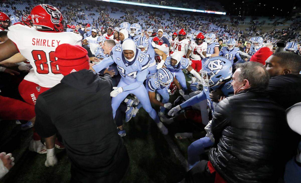 N.C. State and North Carolina players scuffle after N.C. State’s 35-30 victory over UNC at Kenan Stadium in Chapel Hill, N.C., Saturday, Nov. 30, 2024.