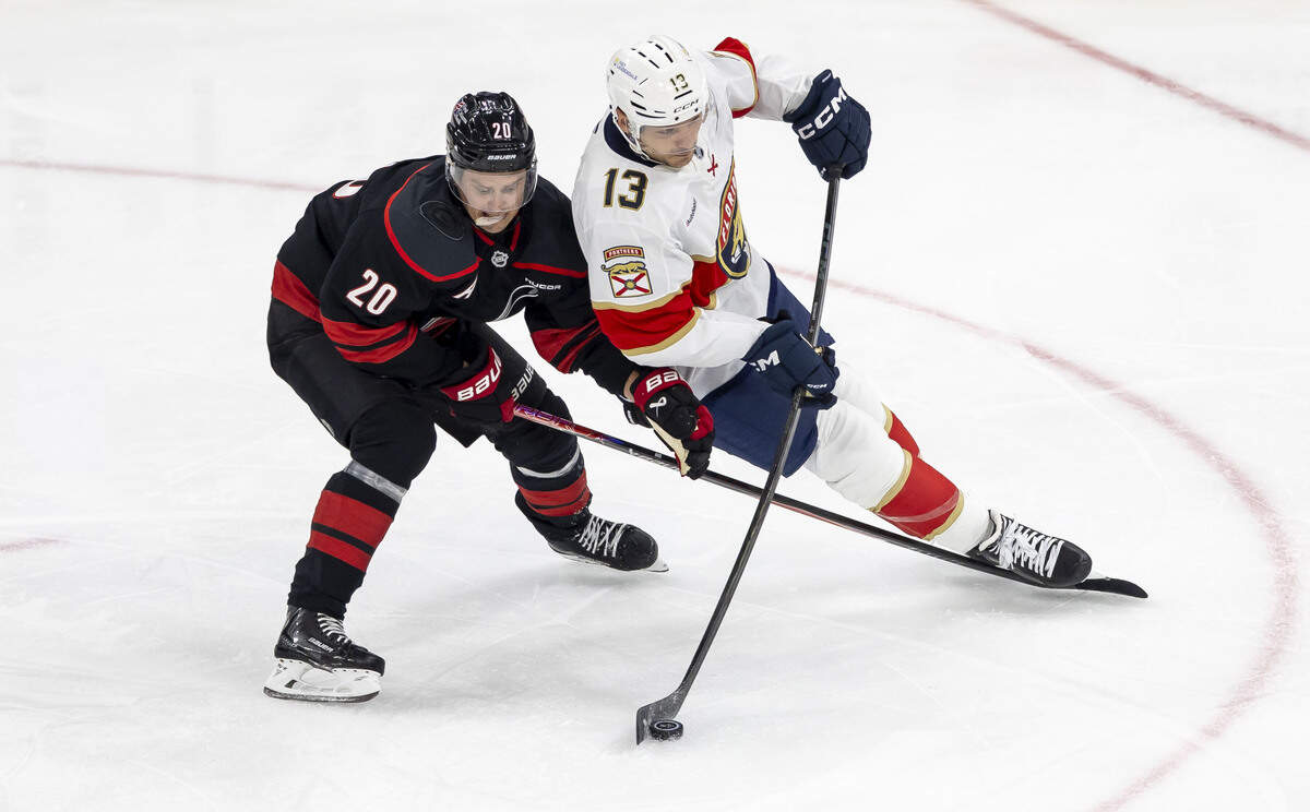 Carolina Hurricanes center Sebastian Aho (20) trips Florida center Sam Reinhart (13) in the second period on Tuesday, Sept. 29, 2026, at Lenovo Center in Raleigh, N.C.