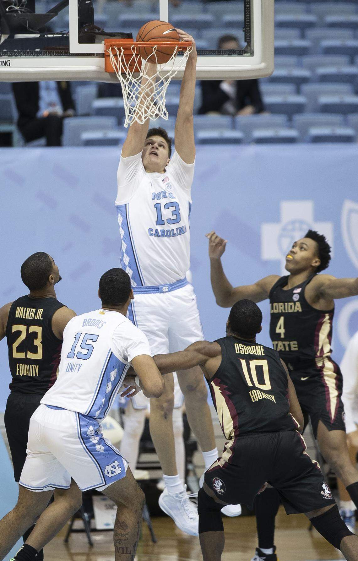 North Carolina’s Walker Kessler (13) gets a dunk over the Florida State defense of M.J. Waller (23), Malik Osborne (10) and Scottie Barnes (4) in the second half Saturday, February 27, 2021 in Chapel Hill, N.C.