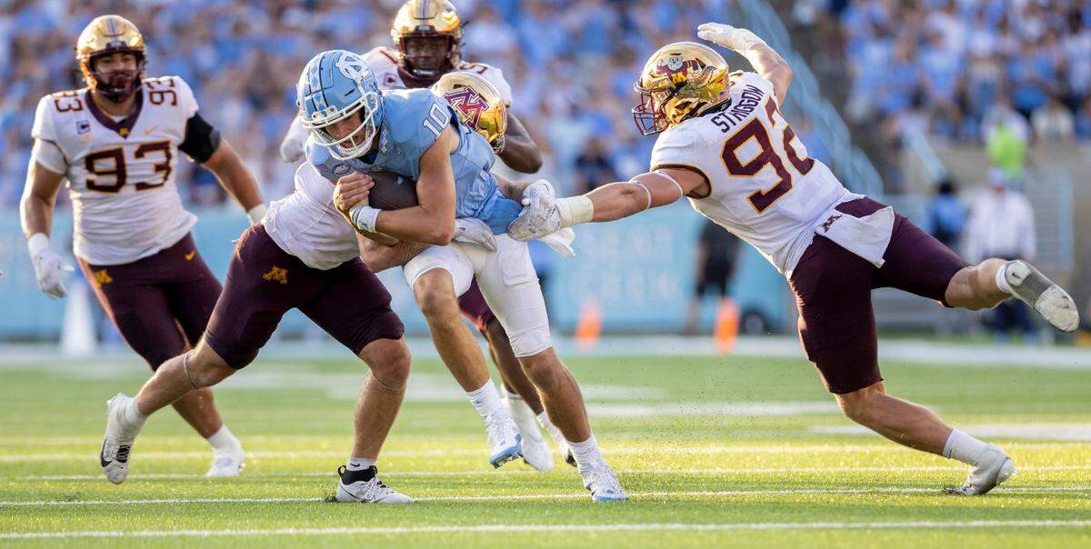 Minnesota’s Maverick Baranowski (6) and Danny Striggow (92) stop North Carolina quarterback Drake Maye (10) for no gain in the fourth quarter on Saturday, September 16, 2023 at Kenan Stadium in Chapel Hill N.C.