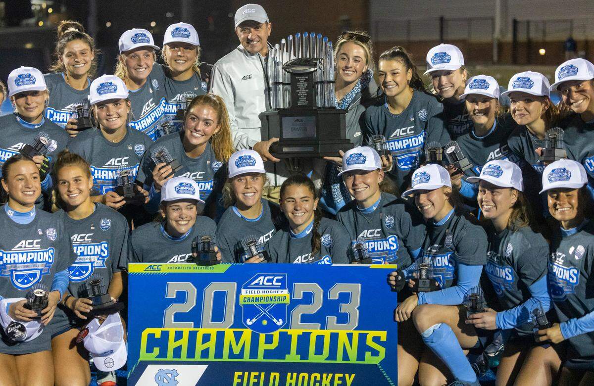 North Carolina field hockey coach Erin Matson accepts the ACC Championship trophy from commissioner Jim Phillips following the Tar Heels’ 2-0 victory against Duke on Friday, November 3, 2023 in Charlottesville, Va. The Tar Heels claimed their seventh consecutive ACC Championship, and the first for Matson as head coach.