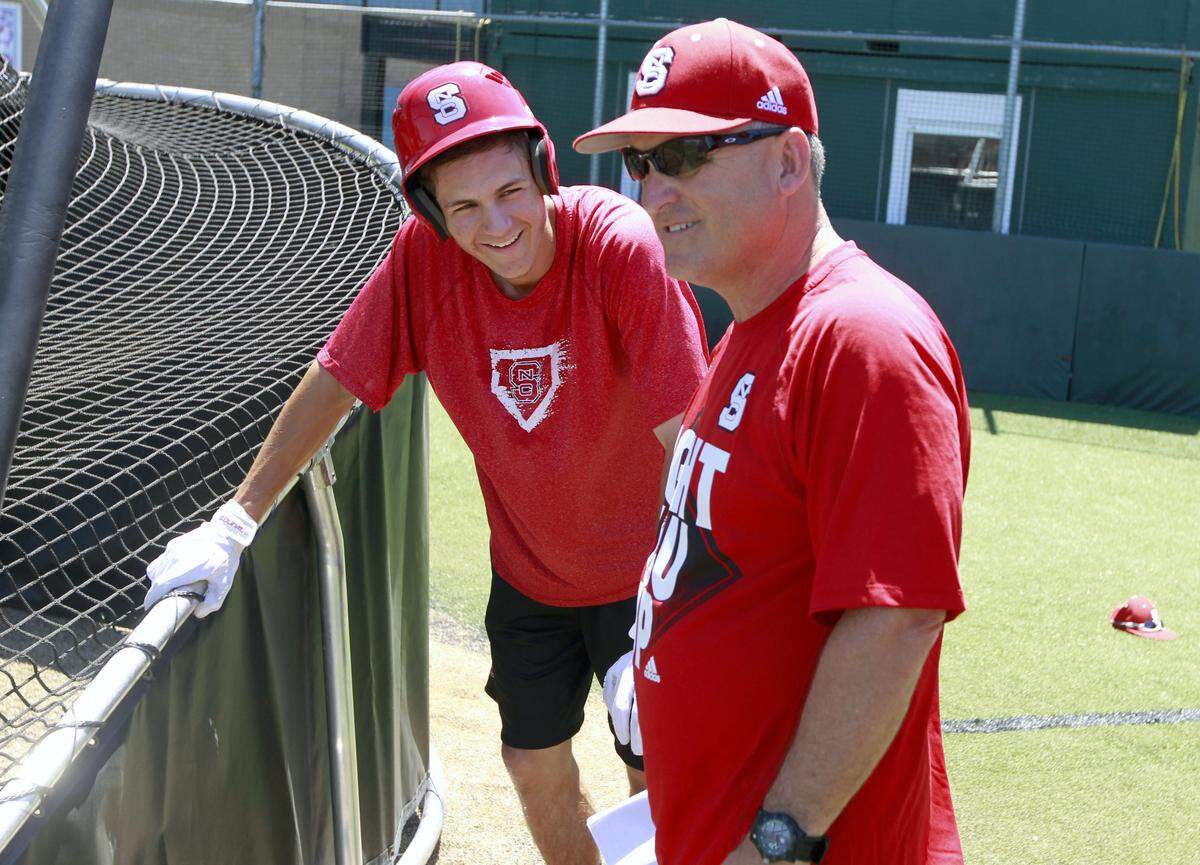 N.C. State's Trea Turner (8) laughs with coach Elliott Avent during N.C. State's practice Monday, June 17, 2013, in Omaha, Nebraska.