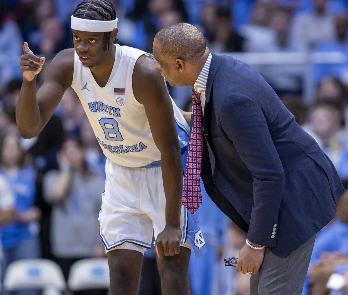 North Carolina coach Hubert Davis talks with forward Caleb Wilson (8) during their game against East Carolina on Dec. 22.