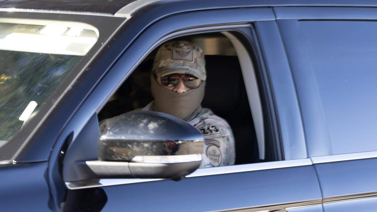 A Border Patrol agent searches a neighborhood in Southeast Raleigh, Nov. 18, 2025. North Carolina’s high school graduation rate could drop due to students leaving school amid the federal immigration actions..