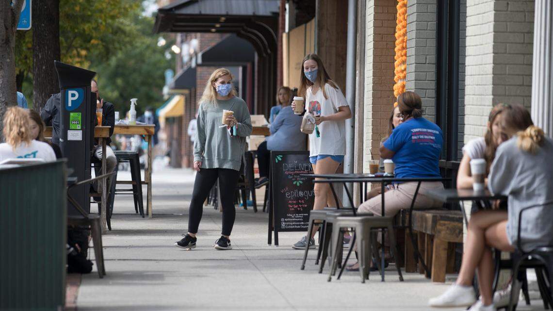 Students look for a seat outside after getting coffee on Franklin St. in Chapel Hill, N.C. on Friday, Oct. 9, 2020.