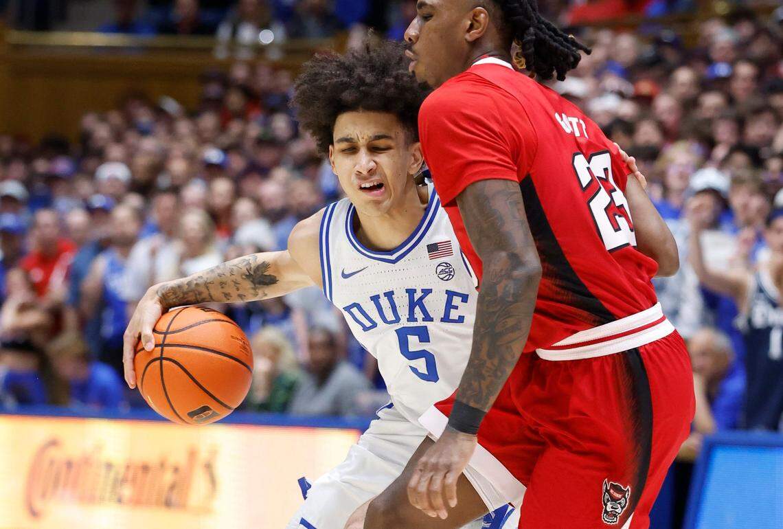 Duke’s Tyrese Proctor (5) gets around N.C. State’s Greg Gantt (23) during the first half of N.C. State’s game against Duke at Cameron Indoor Stadium in Durham, N.C., Tuesday, Feb. 28, 2023.