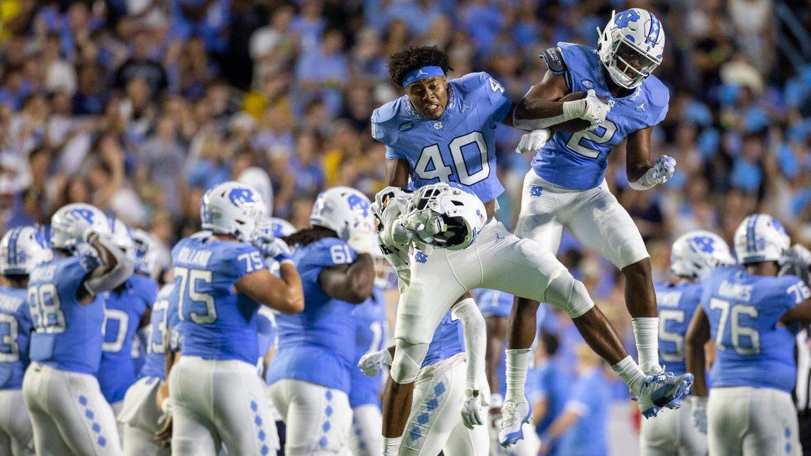 North Carolina’s Don Chapman (2) celebrates with teammate Tyler Thompson (40) with after intercepting a pass by Appalachian State quarterback Joey Aguilar (4) in the third quarter on Saturday September 9, 2023 at Kenan Stadium in Chapel Hill, N.C. 