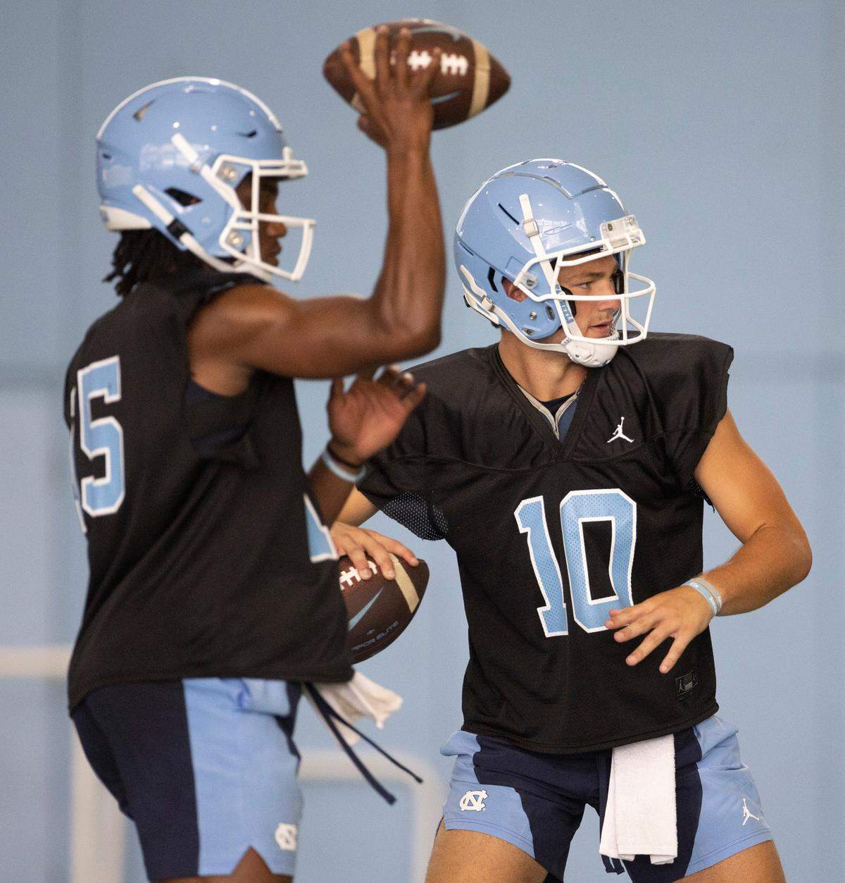 North Carolina quarterback Drake Maye (10) and Conner Harrell (15) works out during the Tar Heels’ first practice of the season on Wednesday, August 2, 2023 in Chapel Hill, N.C.