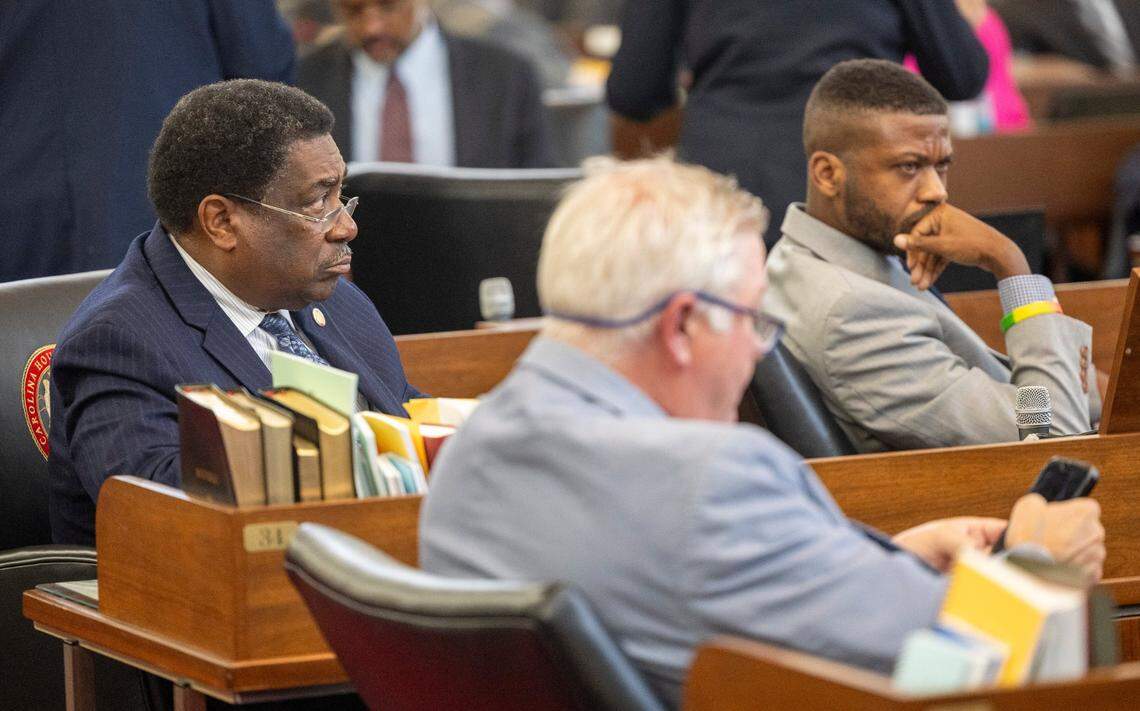 Democrats Reps. Garland Pierce of Hoke and Scotland Counties, left, and Cecil Brockman of Guilford County, right, listen to debate as lawmakers prepare to hold the first of several votes on the budget at the General Assembly.