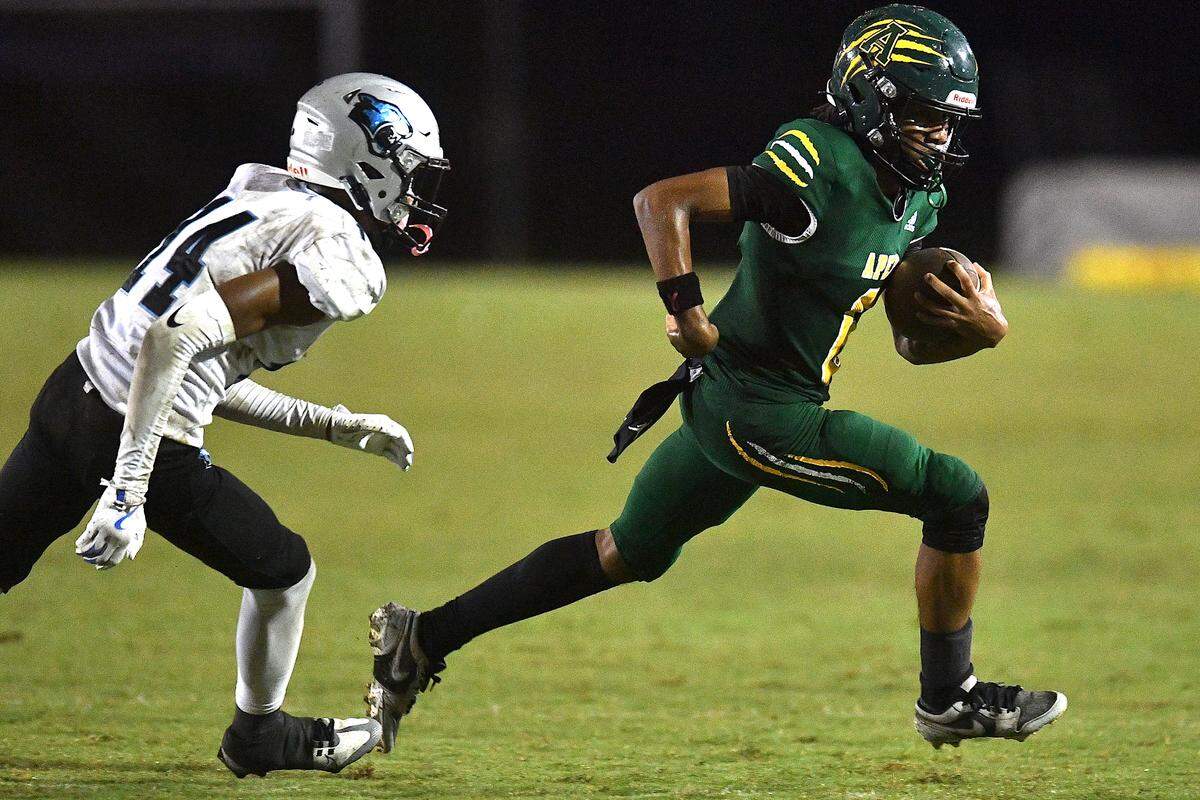 Apex wide receiver Coby Walker (6) runs cross field ahead of Panther Creek’s Elijah Quick (14) during the second half. The Apex Cougars and the Panther Creek Catamounts met in a conference football game in Apex, N.C. on September 20, 2024.