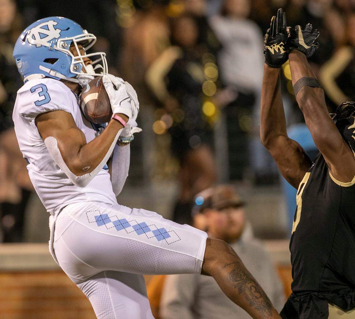 North Carolina’s Antoine Green (3) pulls in a 45 yard pass from quarterback Drake Maye over Wake Forest’s Isaiah Wingfield (8) in the first quarter on Saturday, November 12, 2022 at Truist Field in Winston-Salem, N.C.