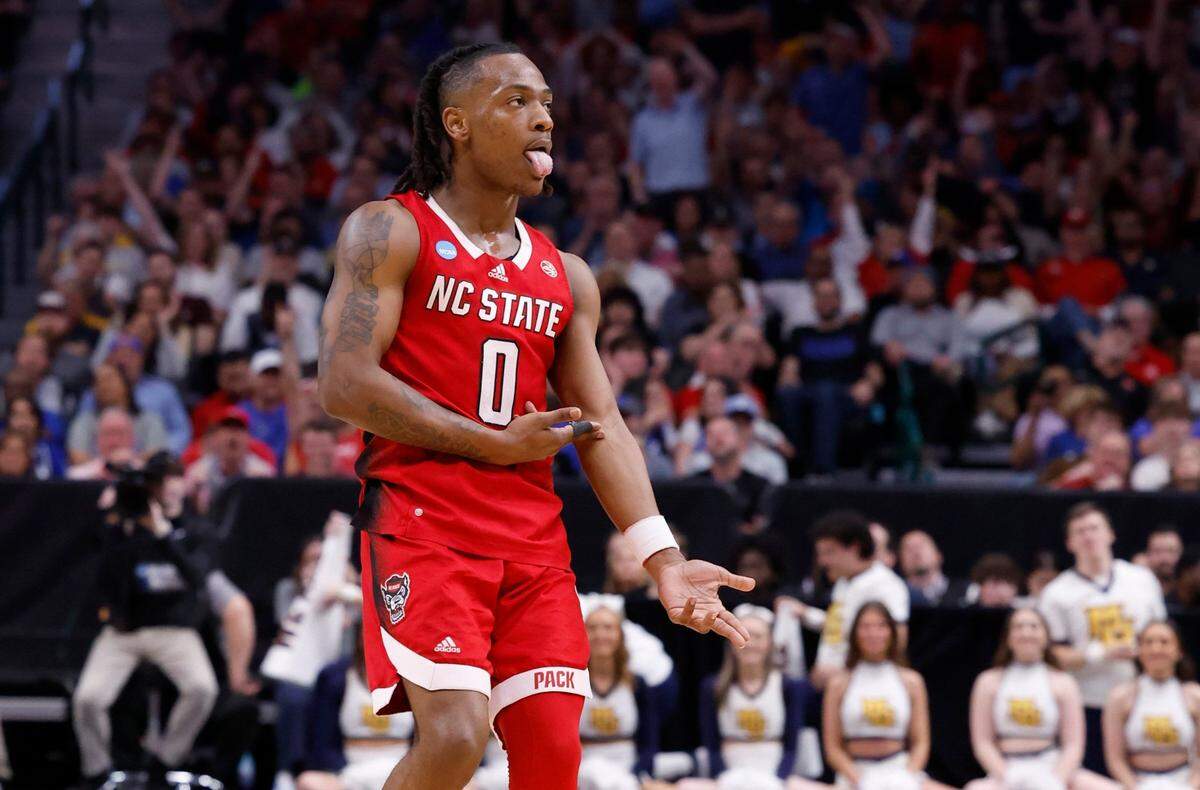 N.C. State’s DJ Horne (0) celebrates making a three-pointer during the second half of N.C. State’s 67-58 victory over Marquette in their NCAA Tournament Sweet 16 game at the American Airlines Center in Dallas, Texas, Friday, March 29, 2024.
