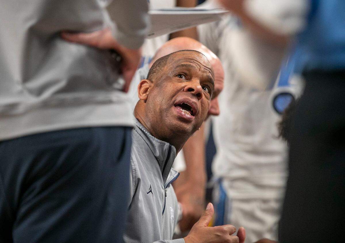 North Carolina coach Hubert Davis huddles with his players during a time-out in the second half against Marquette on Thursday, March 17, 2022 during the NCAA Tournament at Dickies Arena in Ft. Worth, TX.
