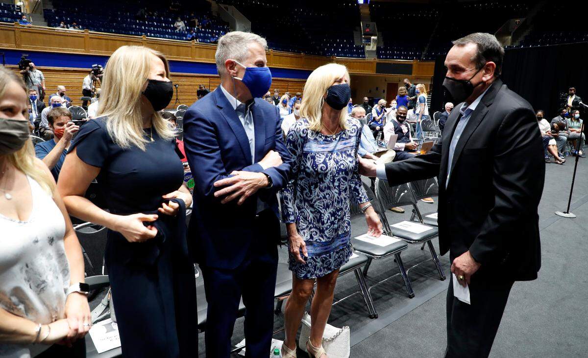 Duke coach Mike Krzyzewski talks with Jon Scheyer’s family, from left, sister Jenifer Resnick, sister Brooke Scheyer, and parents Jim and Laury Scheyer before a press conference introducing Jon Scheyer as Duke basketball’s 20th head coach at Cameron Indoor Stadium in Durham, N.C., Friday, June 4, 2021.