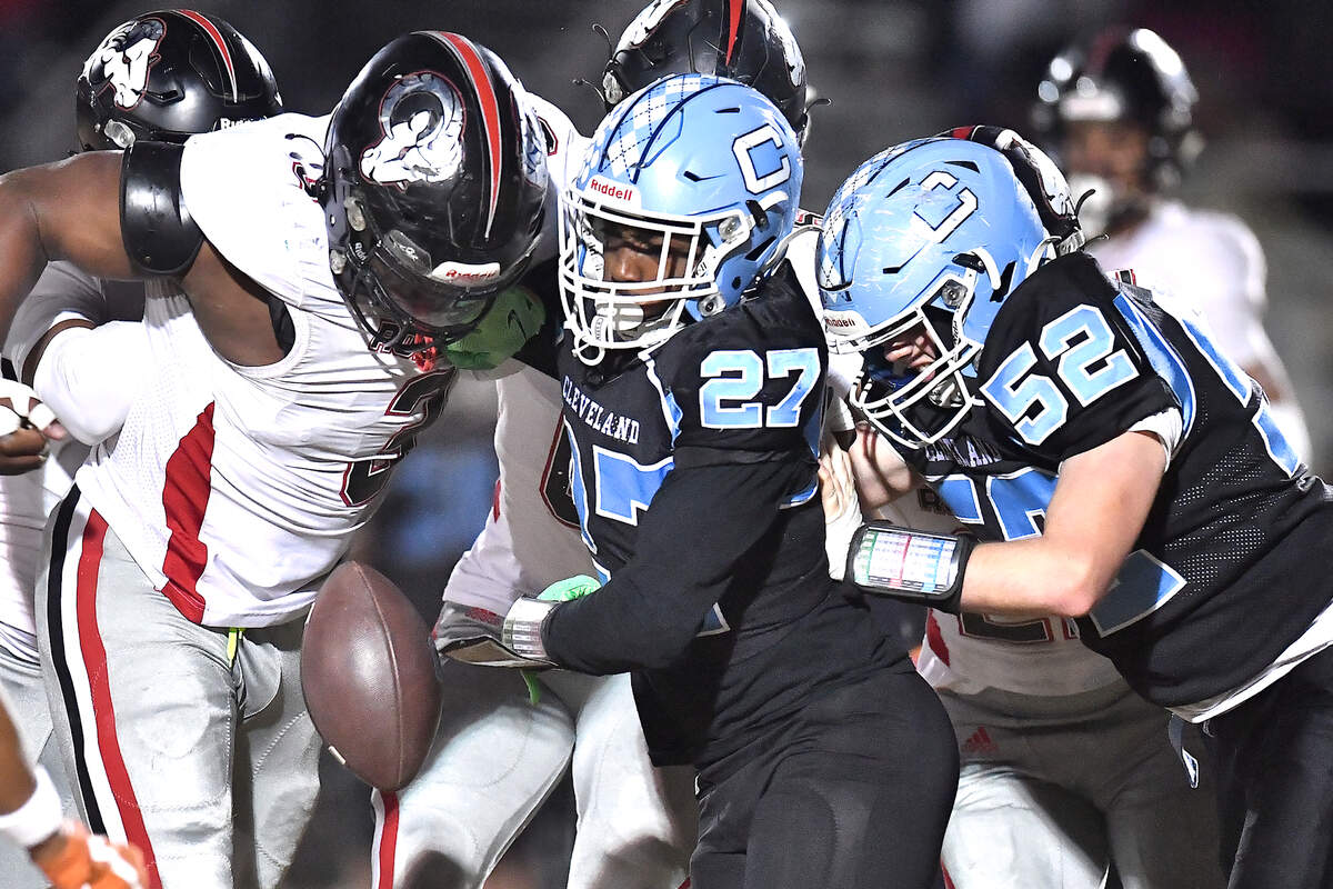 Rolesville’s Xavier Lewis (3) forces the fumble by Cleveland running back Kaleb Ferrell (27) during the first half. The Rolesville Rams and the Cleveland Rams met in the fourth round of the NCHSAA 4A football playoffs in Clayton, N.C. on December 6, 2024.